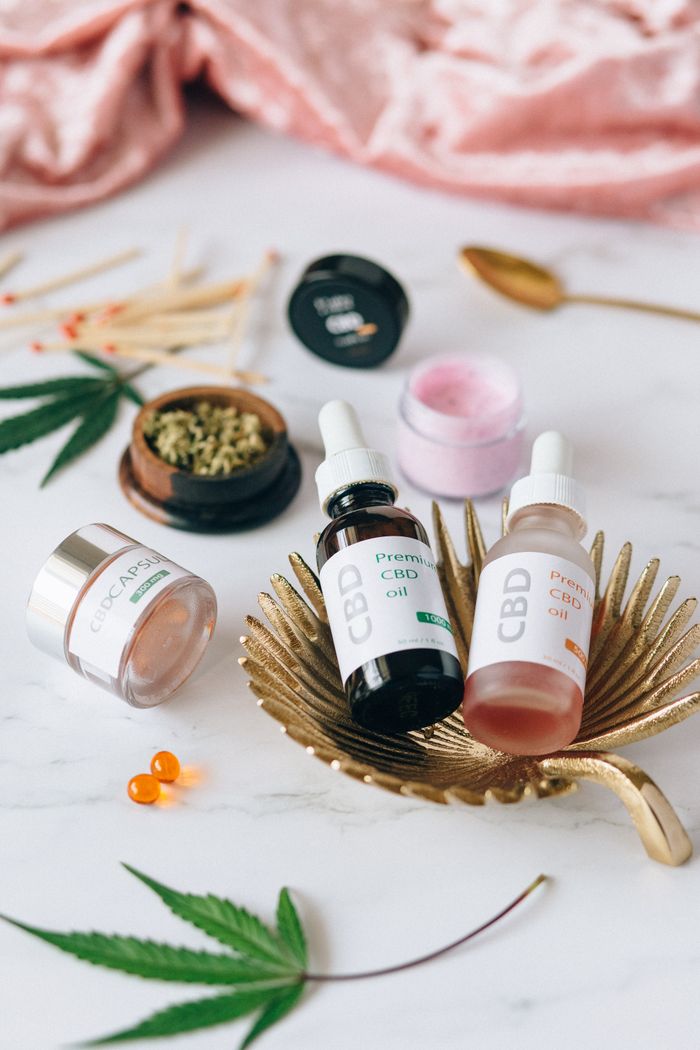 Stylish presentation of CBD oil and hemp products with elegant styling on marble surface.