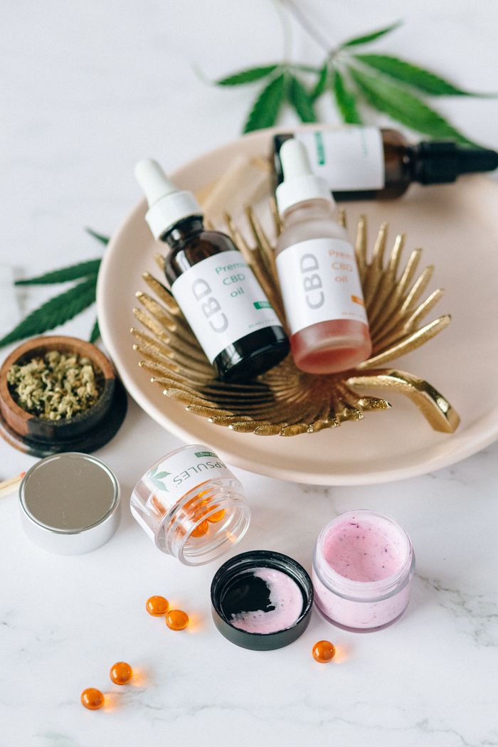 Elegant display of various CBD products including oils and creams with a natural backdrop.